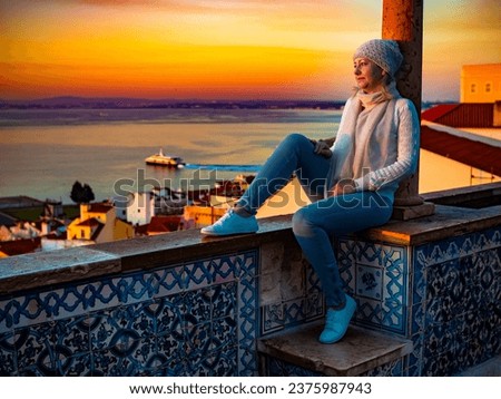 Woman sitting at Santa Luzia viewpoint in Lisbon Royalty-Free Stock Photo #2375987943