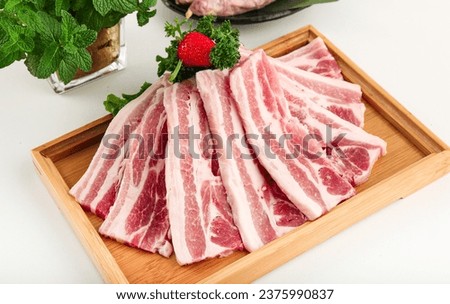 Sliced raw streaky pork in a white dish for the Yakiniku, Sukiyaki, barbecue and Shabu. Royalty-Free Stock Photo #2375990837