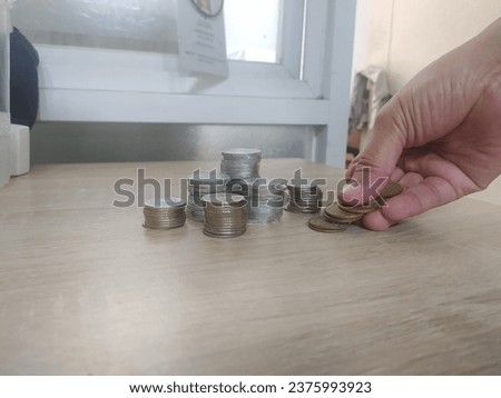 Saving money concept preset by female hand putting money coin

