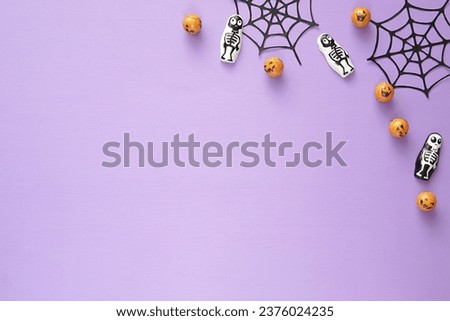 Purple Halloween background mockup for design, product or text presentation, trick or treat, Halloween party decoration, copy space, flat lay composition.          