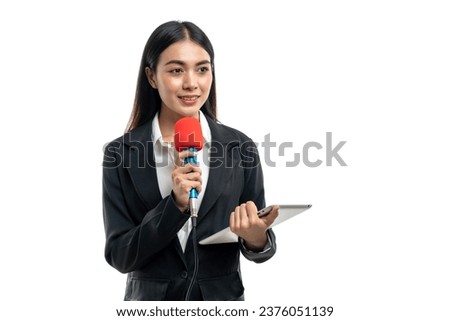 Beautiful Asian female reporter holding tablet while speaking into microphone isolated on white background