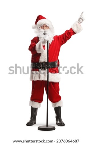 Santa claus with a microphone singing and pointing with finger isolated on white background