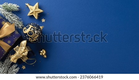 Gleaming Yuletide magic notion. Top view picture of glistening blue and gold-wrapped gifts, star toy, bright confetti, fir twigs with frost on elegant blue surface, available for your text or ad