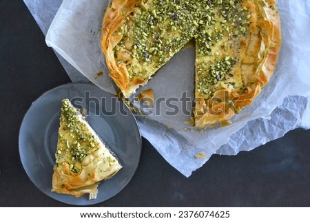 Sliced baklava cheesecake aerial picture, delicious slice of filo pastry filled with cheesecake and pistachio baklava 