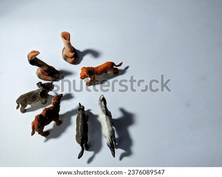Group of wild animal toys isolated on a white background. Small miniature animal toys for kids. 