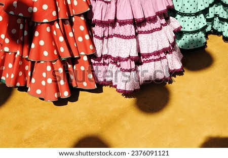 Women dresses of spanish fair. Flamenco dresses (vestidos de flamenca) in April Fair of Seville. Royalty-Free Stock Photo #2376091121