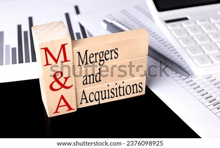 Word M and A Mergers Acquisitions made with wood building blocks, business