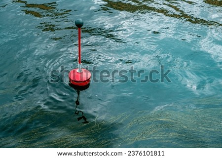 A buoy in seawater.Red float in the sea.