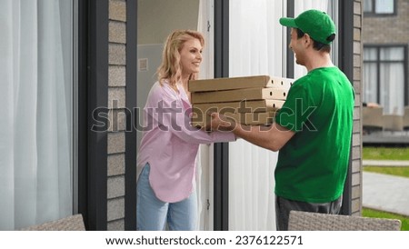 Lot pizza box deliver. Man give many hot pie. Fast food delivery service. Joy girl meet pizzeria courier. Young adult person order take away meal. Tasty pizza home delivery. Online city eat cafe job. Royalty-Free Stock Photo #2376122571