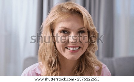 Happy 30s woman look camera. Smile girl face portrait. Positive emotion close up. Cute female blue eyes gaze. One joy lady have fun. Nice mom sit sofa head shot. Pretty blond hair. Young adult person. Royalty-Free Stock Photo #2376122655