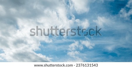 Decorative clouds float across the sky, creating an epic landscape. The panoramic image serves as a versatile texture, background, and graphic resource, providing ample space for design and copy.