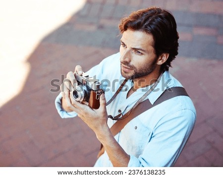 Camera, photographer or tourist in city to travel on holiday vacation trip for creativity or tourism adventure. Photography, thinking or man with pictures for sightseeing in urban town from above