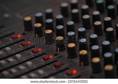 Mixer control. Music engineer. Backstage controls on an audio mixer, Sound mixer. Professional audio mixing console with lights, buttons, faders and sliders. sound check for concert.  Royalty-Free Stock Photo #2376143503