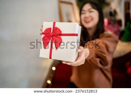 Happy excited asian woman hands holding Christmas gift box. cheerful girl packing Xmas present or open box xmas new year birthday gift.