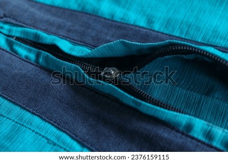 close up of Koko's shirt zipper