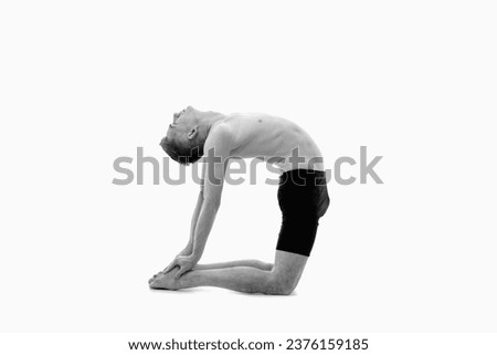 Ustrasana (Camel pose), Ashtanga yoga  Side view of man wearing sportswear doing Yoga exercise against white background. Black and white image.