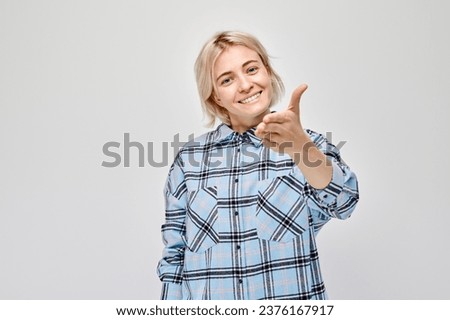 Portrait of confident girl chooses you points finger at camera isolated on white studio background. Welcome gesture, join our team concept
