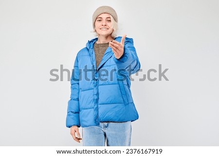 Portrait of confident girl chooses you points finger at camera isolated on white studio background. Welcome gesture, join our team concept