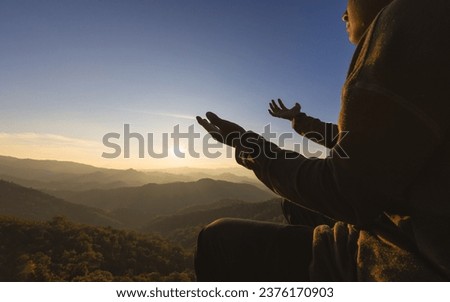 Silhouette of christian man hand praying,spirituality and religion,man praying to god. Christianity concept.  Pray for god blessing to wishing have a better life.