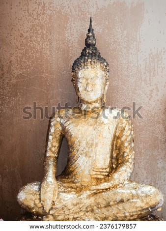 Antique gilded Buddha statue in meditation posture
