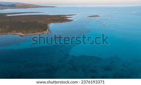 Aerial photo of the island of Isola Piana near Stintino and the beach of Spiaggia La Pelosa. Mountainous island, blue water and clear sky. Northwest part of Sardinia, Sassari Province, Italy. Royalty-Free Stock Photo #2376193371