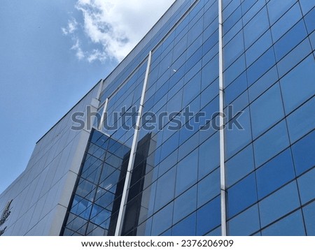 Stunning Blue Facade Glass Building – Modern Architectural Marvel, Perfect for Business, Urban, and Futuristic Concepts. High-Quality Stock Photo.