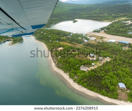 Aerial view of Port Alsworth, Alaska within Lake Clark National Park and Preserve. Private Port Alsworth Airport, public Wilder Natwick Airport, Hardenburg Bay. View from seaplane.  Royalty-Free Stock Photo #2376208915