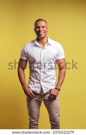 Portrait of a Brazilian wearing button-up shirt and jeans, smiling, with hands in pocket, looking at camera - Belém - Pará - Brazil Royalty-Free Stock Photo #2376222279