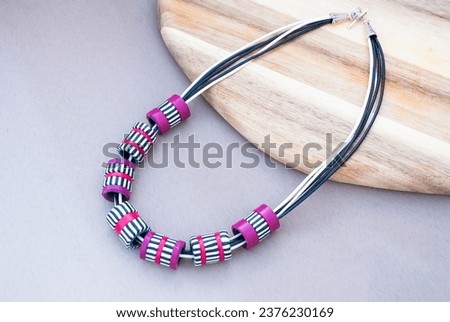 Striped black and white necklace of polymer clay. Handmade jewelry. Royalty-Free Stock Photo #2376230169