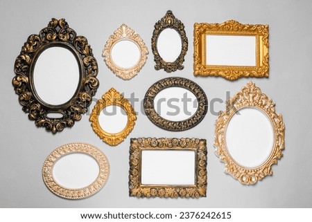 Empty vintage frames hanging on light gray wall