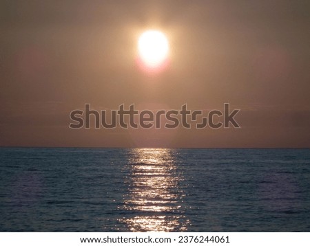 Dusky sun, photo, sunset, reflection. Royalty-Free Stock Photo #2376244061