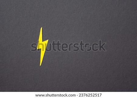Yellow cut out lighting on black background. Idea concept. Energy and electricity. Innovation and thinking out the box symbols. Creativity and inspiration. Copy space