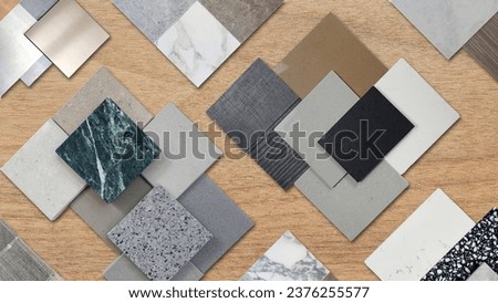 samples of interior material contains ceramic tiles, artificial stones, marbles, stainless, quartz, terrazzo placed on wood table. interior design selected material for idea. Royalty-Free Stock Photo #2376255577