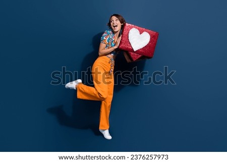 Full body photo of pretty young girl look empty space heart icon notification wear flared pants isolated on dark blue color background