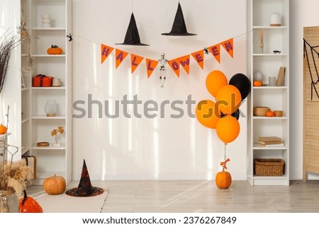 Interior of living room decorated for Halloween with shelf units