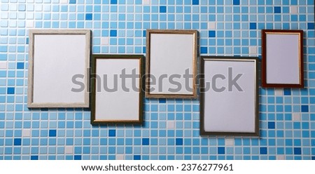 Group of blank frames on a tiled wall