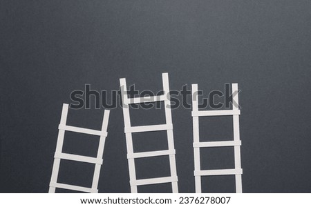 White paper stairs on dark gray background. Business concept