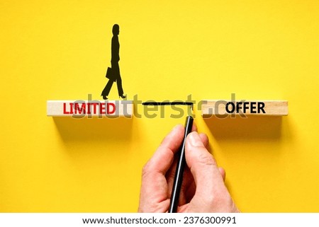 Limited offer symbol. Concept words Limited offer on beautiful wooden block. Beautiful yellow table background. Businessman hand. Business marketing, motivational Limited offer concept. Copy space.