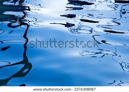 Reflection of sun on ships at sea, water in sunlight, abstract art for design, water texture. water reflection texture background. Dark background, high resolution background dark water surface 