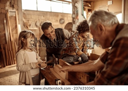 Young future carpenters learning the ways of their elders in a wood shop