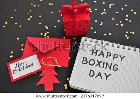 tree next to merry christmas card and gift box - happy boxing day background 