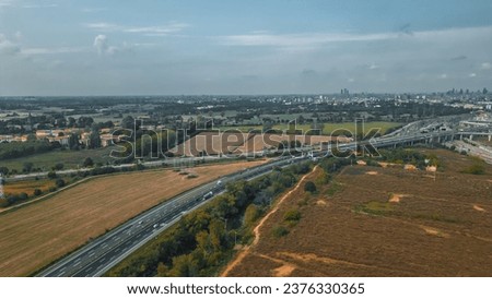 Aerial Views of Highways and Motorways on Italy with Moving Traffic. Milano, Lombardia, Autostrada A1 Royalty-Free Stock Photo #2376330365