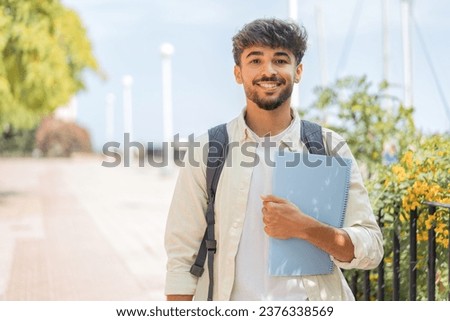 Young student Arabian man at outdoors smiling a lot Royalty-Free Stock Photo #2376338569