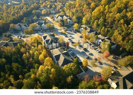 Aerial view of new apartment houses between yellow trees in South Carolina suburban area in fall season. Real estate development in American suburbs Royalty-Free Stock Photo #2376338849