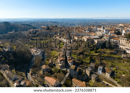 Aerial view of dense historic center of Thiers town in Puy-de-Dome department, Auvergne-Rhone-Alpes region in France. Rooftops of old buildings and narrow streets Royalty-Free Stock Photo #2376338871