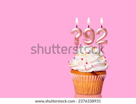 Birthday Cake With Candle Question Mark And Number 92 - On Pink Background.