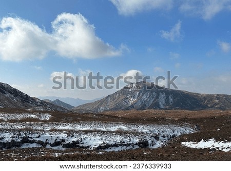 Winter Veil: Snow-Clad Mount Aso Grassland Royalty-Free Stock Photo #2376339933