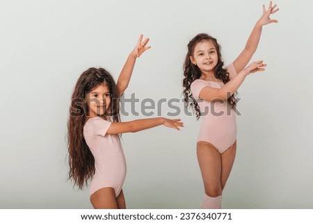 two young ballerinas on a white background