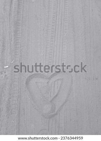 picture of love on the sand on the beach with a grayish brown color and a smooth beach sand texture 