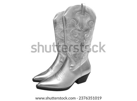 Shiny silver cowboy boots on a white background. Stylish shoes. Concert shoes.